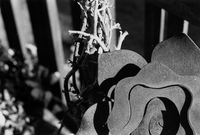 A metal flower sculpture that decorates a potted plant